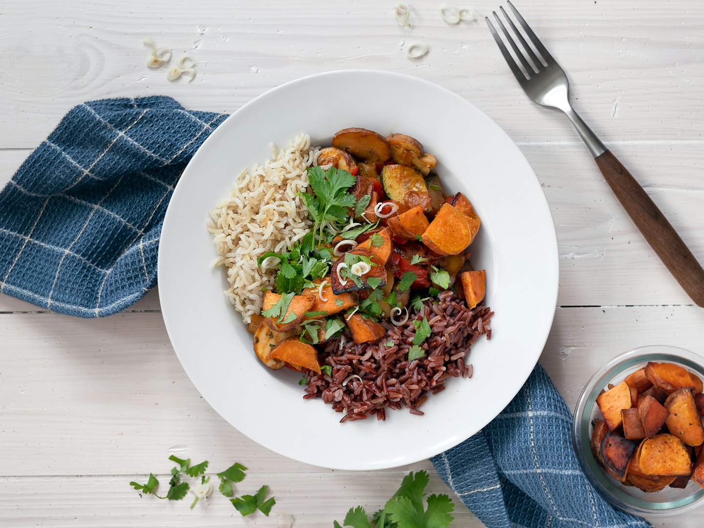 Healthy rice bowl served on a rustic wooden table.